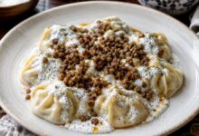 Afghan mantu dumplings with garlic yogurt, meat topping and dried mint