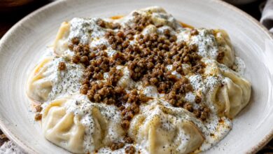 Afghan mantu dumplings with garlic yogurt, meat topping and dried mint