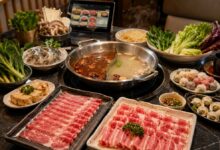 All-you-can-eat hot pot with divided broth, sliced beef and lamb, shrimp, tofu, mushrooms, vegetables, dumplings, noodles, and tablet ordering