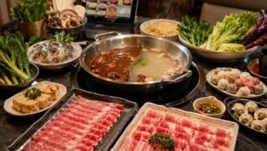 All-you-can-eat hot pot with divided broth, sliced beef and lamb, shrimp, tofu, mushrooms, vegetables, dumplings, noodles, and tablet ordering