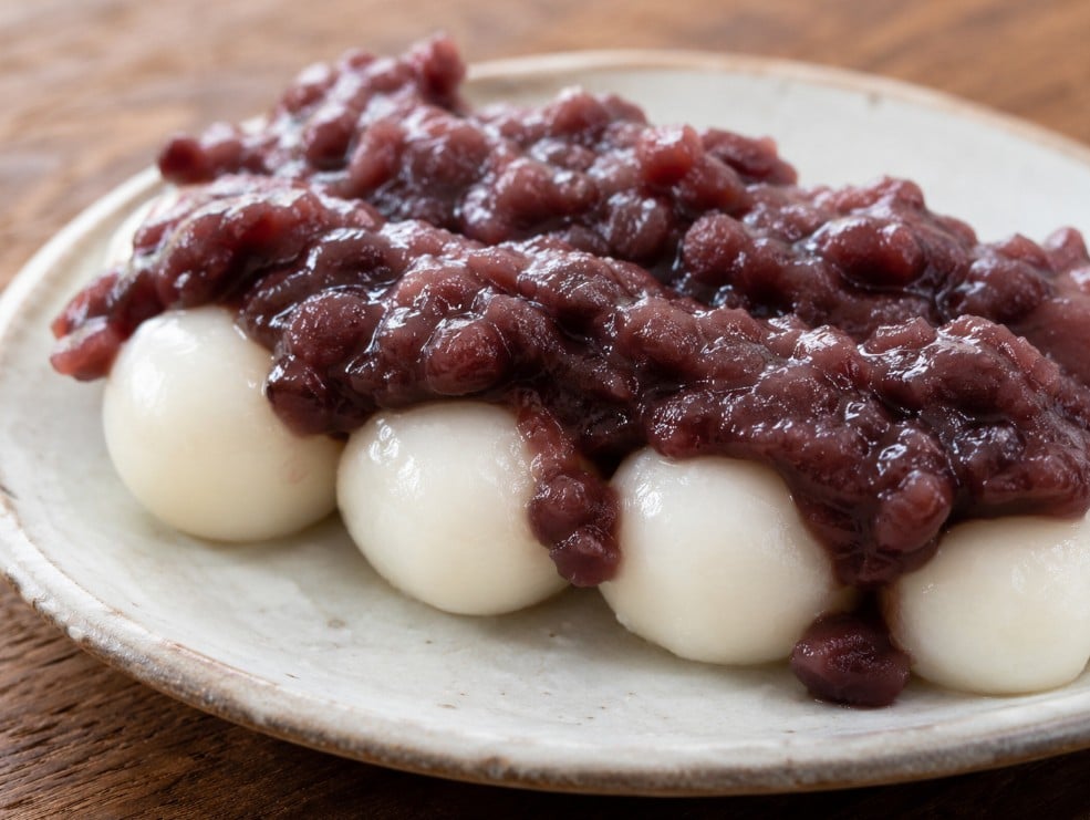 Anko dango topped with sweet red bean paste showing the texture of the rice dumplings and azuki bean topping