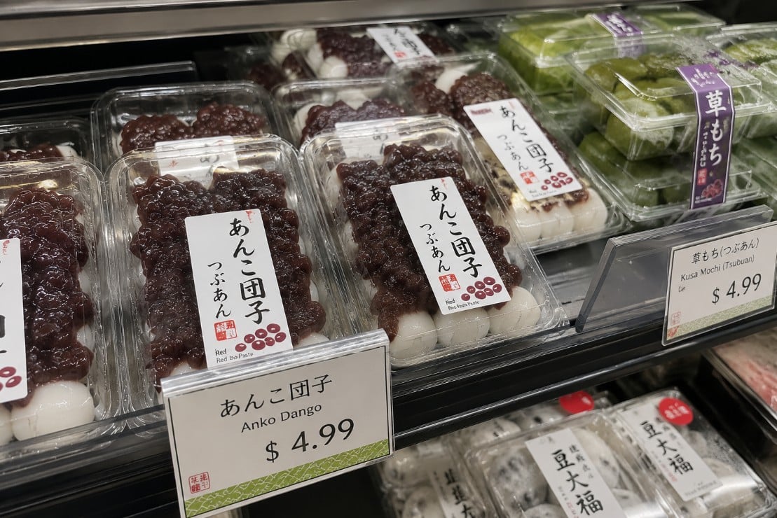 Anko dango displayed with other Japanese wagashi sweets at a specialty market