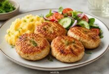 Russian-style chicken kotleti served with mashed potatoes and fresh cucumber tomato salad