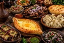 Traditional Georgian table with khachapuri, khinkali, grilled meats, eggplant rolls, sauces and red wine