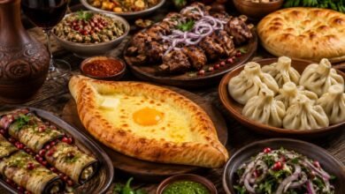 Traditional Georgian table with khachapuri, khinkali, grilled meats, eggplant rolls, sauces and red wine