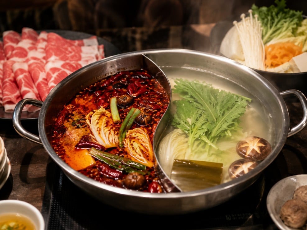 Rich Chinese hot pot broth compared with a light clear Japanese shabu-shabu broth