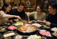Hot pot etiquette with diners using separate tongs, shared ladle, personal chopsticks, and individual sauce bowls