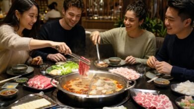 Hot pot etiquette with diners using separate tongs, shared ladle, personal chopsticks, and individual sauce bowls