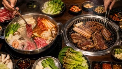 Hot Pot vs Korean BBQ: Differences, Prices and Which One to Choose 15 Hot pot and Korean BBQ on one table with divided broth, sliced meat, seafood, grill, banchan, and dipping sauces
