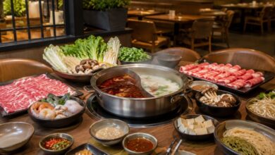 Hot pot in Wichita, Kansas with divided broth, sliced beef, seafood, tofu, mushrooms, greens, noodles, and dipping sauces