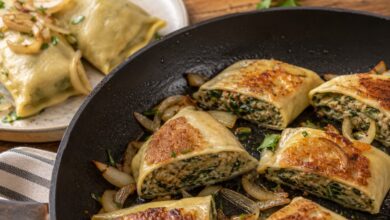 Sliced cooked Maultaschen pan-fried with golden onions and moist meat and spinach filling