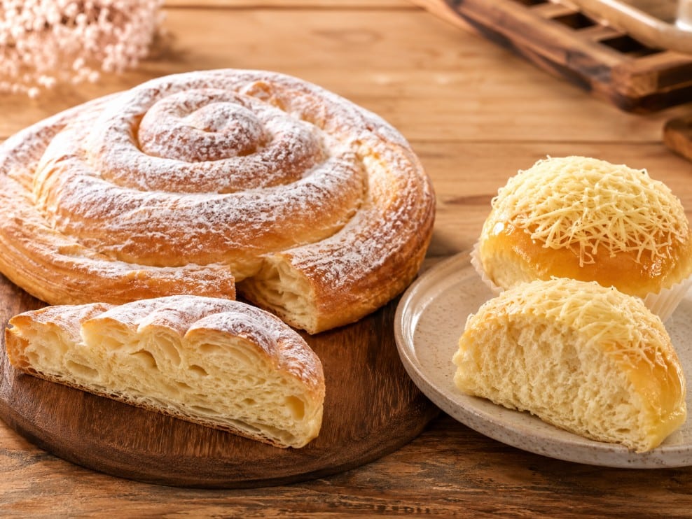Mallorcan spiral ensaimada beside Filipino cheese ensaymada