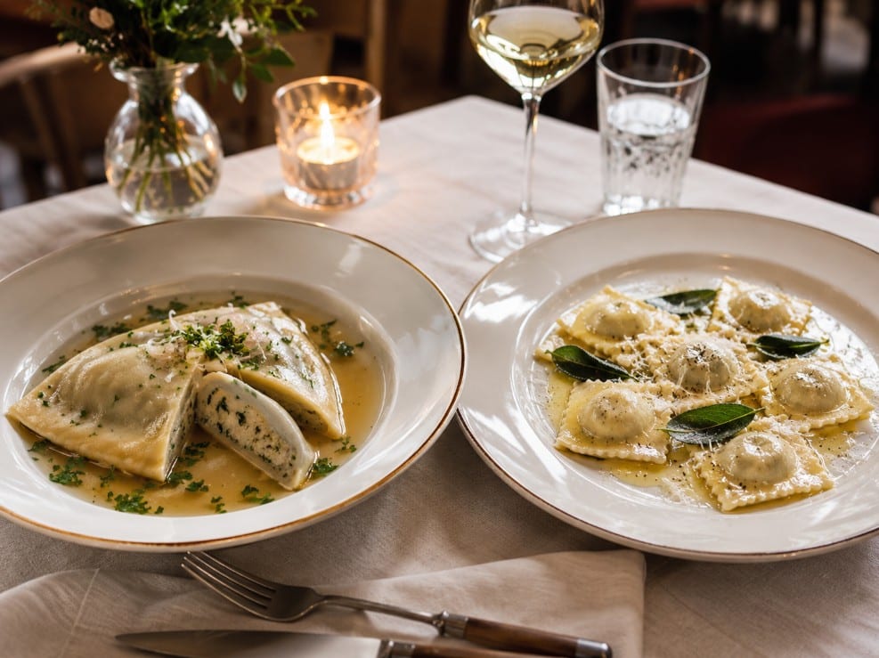 Maultaschen served in clear broth beside Italian ravioli with butter sage and cheese