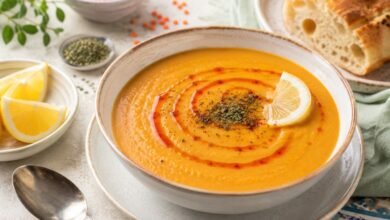 Traditional mercimek çorbası with red lentils, lemon, pepper oil, herbs and fresh bread