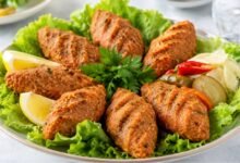 Turkish mercimek köftesi made with red lentils and bulgur, served with lettuce, lemon, parsley and pickled vegetables