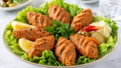 Turkish mercimek köftesi made with red lentils and bulgur, served with lettuce, lemon, parsley and pickled vegetables
