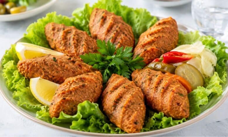 Turkish mercimek köftesi made with red lentils and bulgur, served with lettuce, lemon, parsley and pickled vegetables