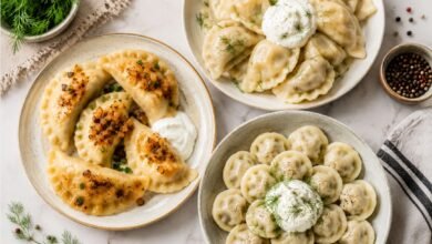 Pierogi versus varenyky versus pelmeni with fried onions, sour cream and fresh dill