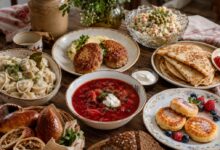 Table with borscht, pelmeni, kotleti, blini, Olivier salad, syrniki, pirozhki and rye bread