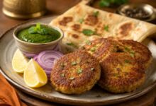 Shami kebab served with mint chutney, red onion, lemon and paratha