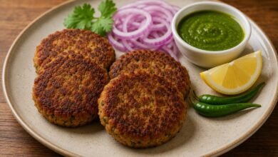 Shami kebab served with green chutney, red onion, lemon and green chilies