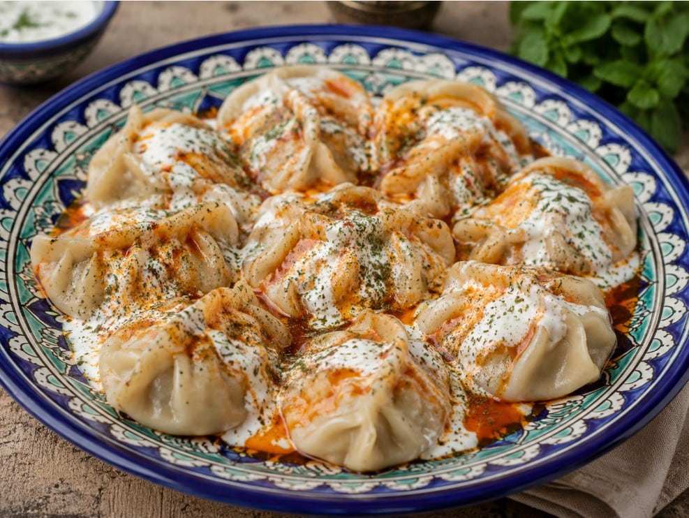 Traditional Afghan mantu with yogurt and lentil sauce
