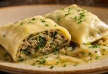 A cut-open Maultasche reveals its tender wrapper and moist spinach-and-meat filling.