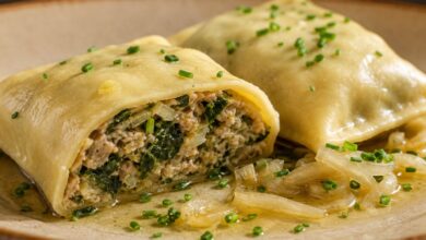 A cut-open Maultasche reveals its tender wrapper and moist spinach-and-meat filling.