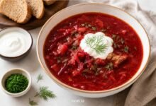 Traditional Ukrainian borshch with sour cream, fresh dill and bread