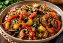 Traditional Georgian ajapsandali with eggplant, tomatoes, peppers, onions and fresh herbs