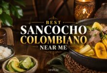 Colombian sancocho with beef, yuca, corn and plantain served with rice and avocado