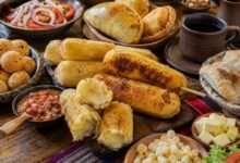 Sonso de yuca near me served on a Bolivian food table with salteñas, cuñapé, salad and coffee