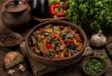 Traditional Georgian ajapsandali with eggplant, tomatoes, peppers, garlic and fresh herbs